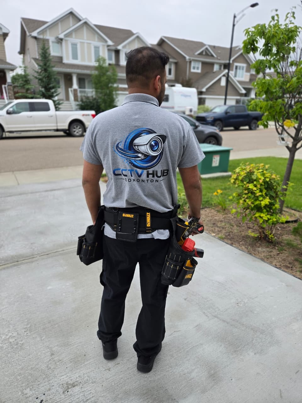 CCTV Hub Edmonton technician walking up a driveway in an Edmonton neighbourhood