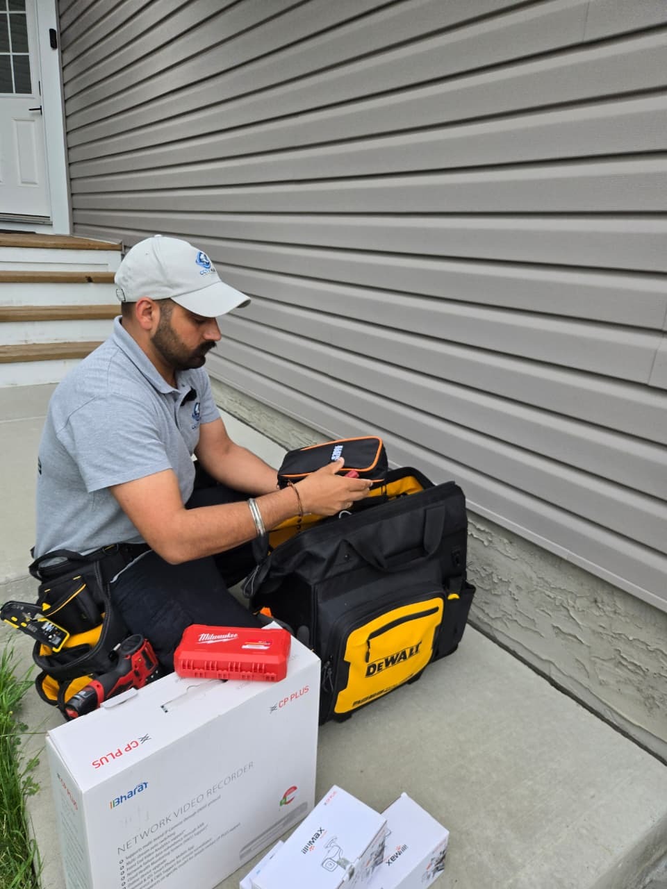 CCTV Hub Edmonton technician organizing tools and diagnostic gear before an install